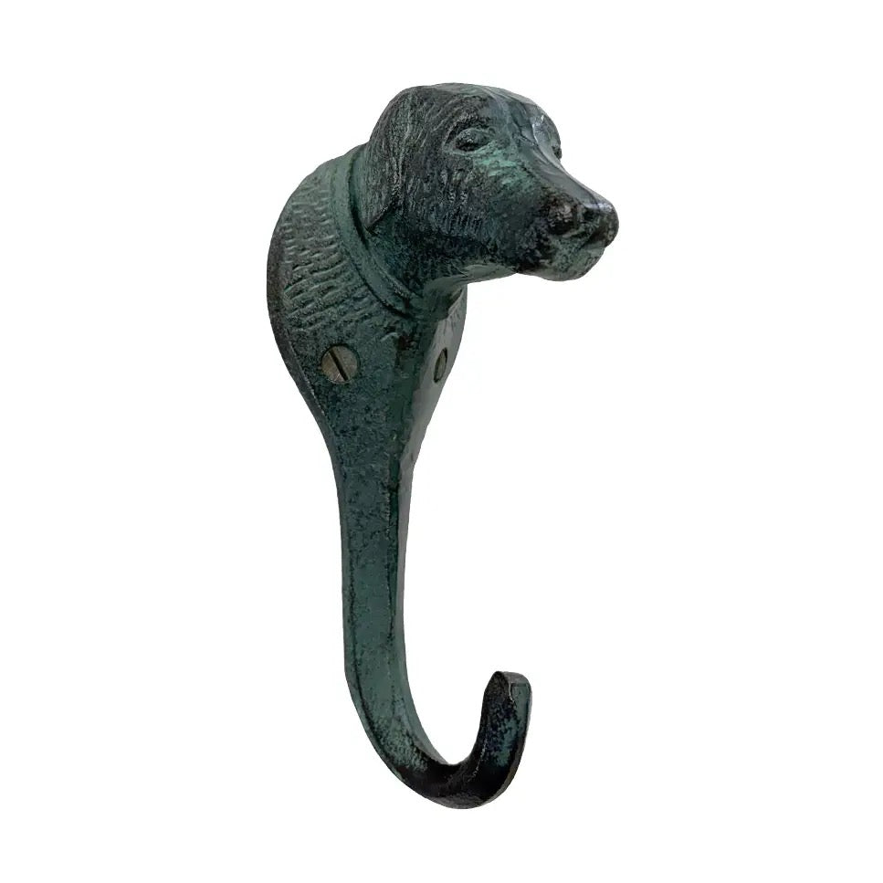 A dog-shaped metal hook with a distressed green and black patina finish, isolated on a white background.
