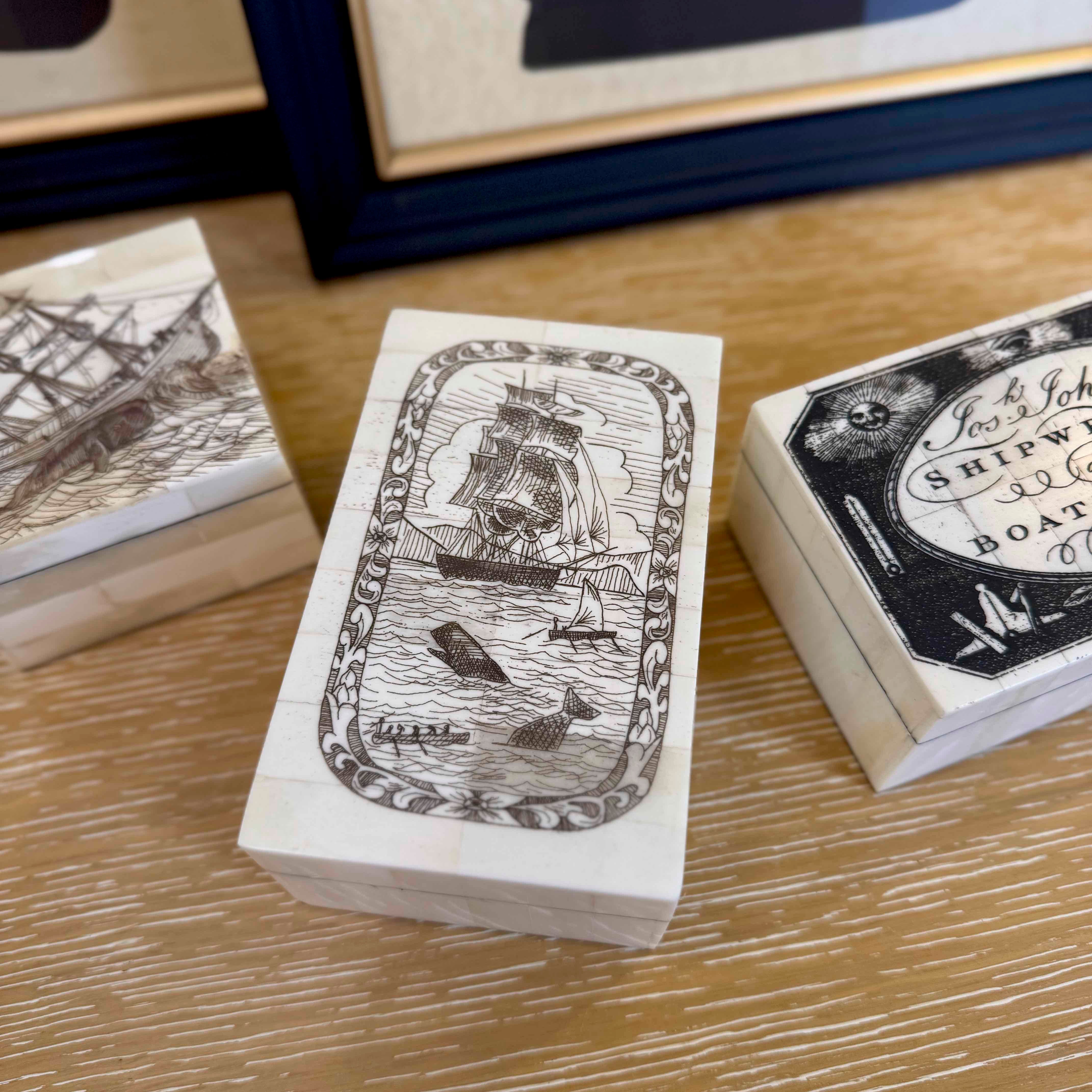 Wooden stamp blocks with ship illustrations on a wooden surface