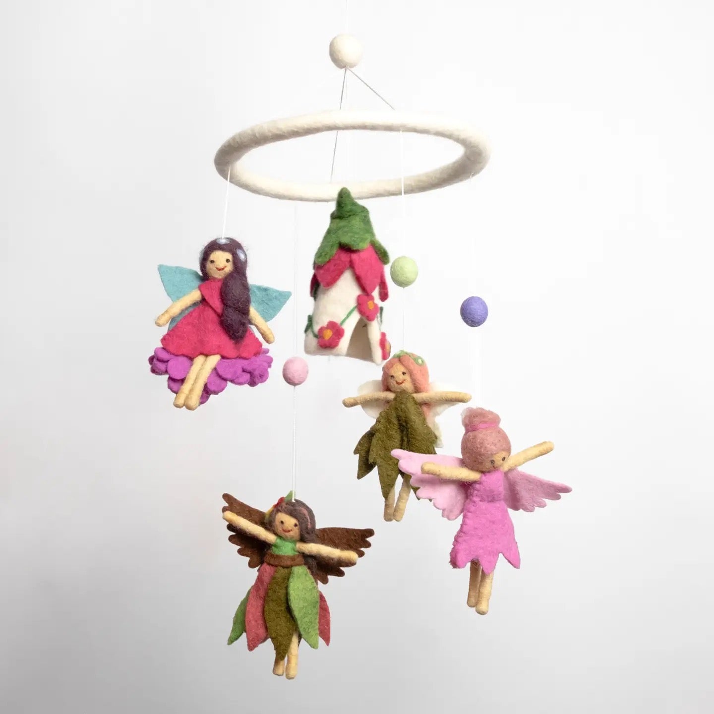 Fairy-themed mobile with colorful fairies and a tree on a white background