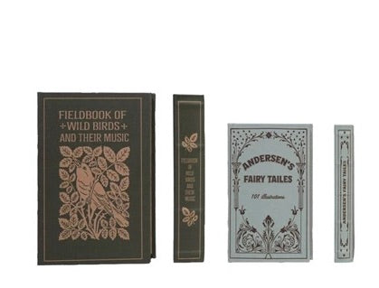 Set of decorative books with ornate covers on a white background