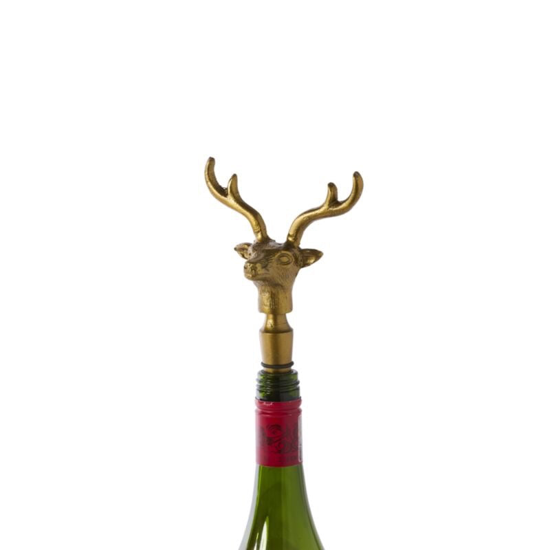 Brass deer head bottle stopper on a white background