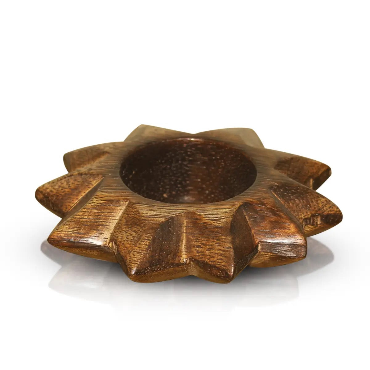 A carved wooden candle holder with a starburst or sunflower-like shape, featuring a smooth circular center and textured, polished wooden petals, shown on a white background with a soft reflection.