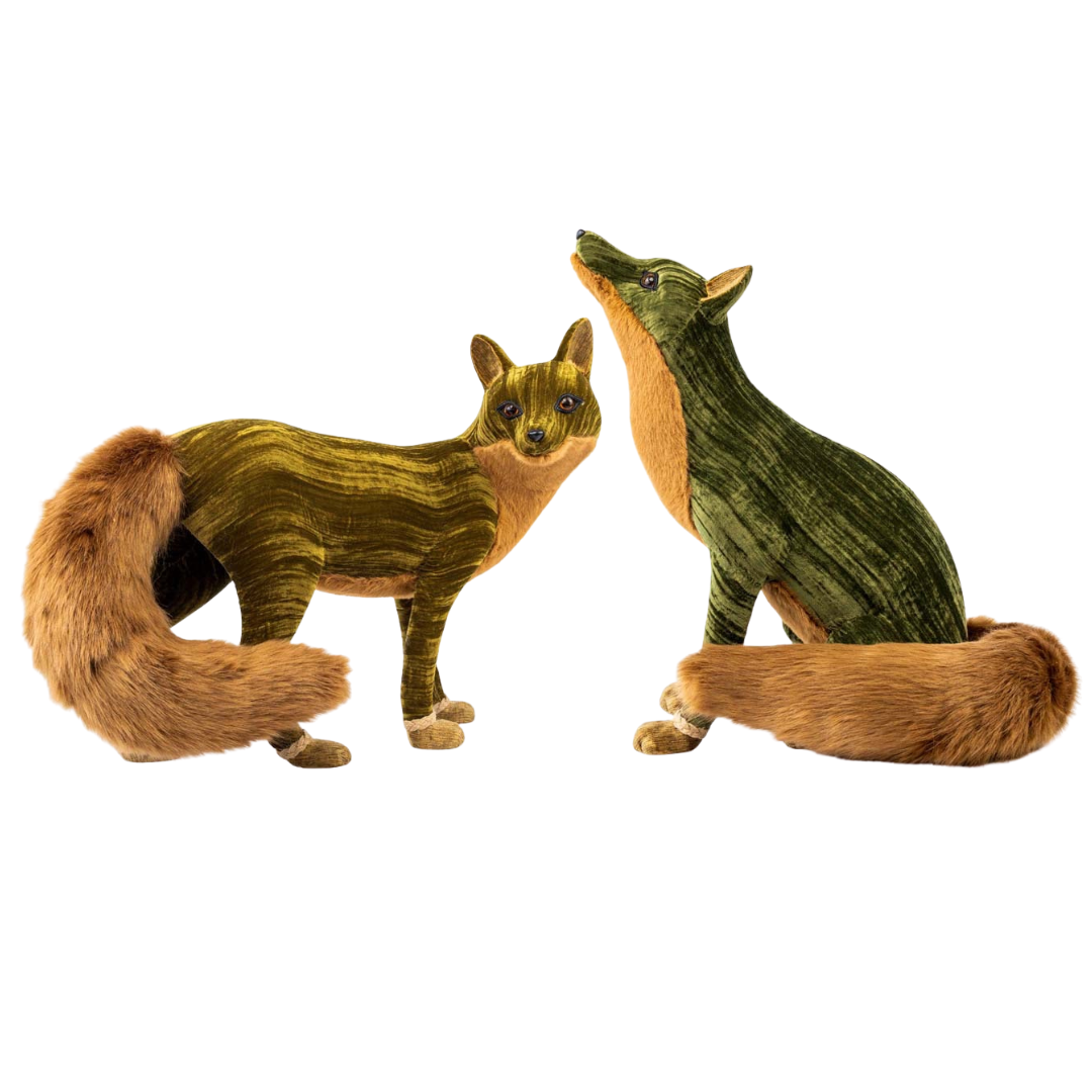 Two toy fox figures on a white background