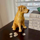 Dog-shaped piggy bank with coins on a surface