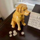 Dog-shaped decorative item on a surface with paw prints