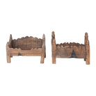 Two wooden planters with decorative tops on a white background