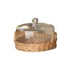 Wicker bread basket with glass lid on a white background