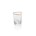 A clear triangular old fashioned glass with gold trimming on the rim.